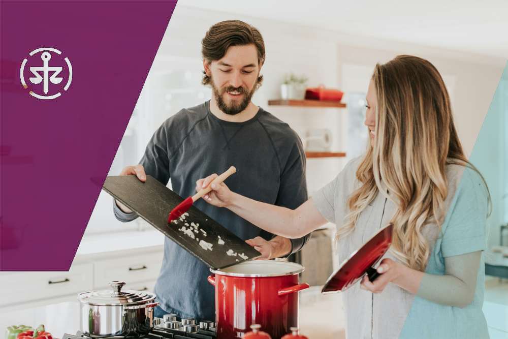 Couple cooking and discussing cohabitation