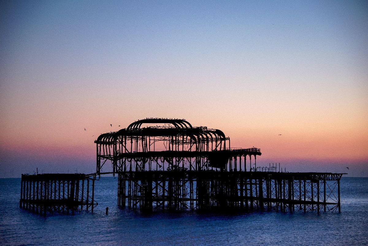 Brighton's West Pier at sunset, viewed from the seafront